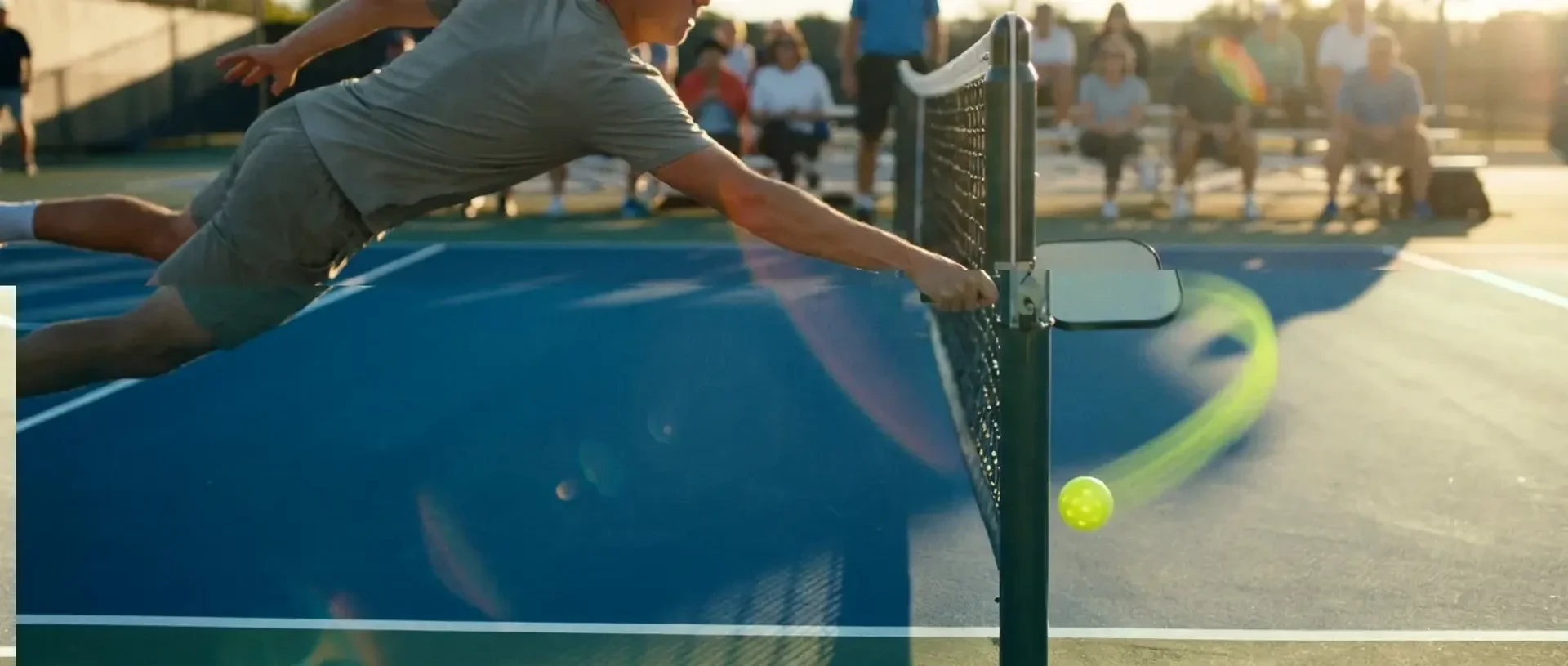 A pickleball player hits an Around-The-Post shot, with the ball passing outside the net post on its way back into the opponent's court — illustrating the ATP shot.